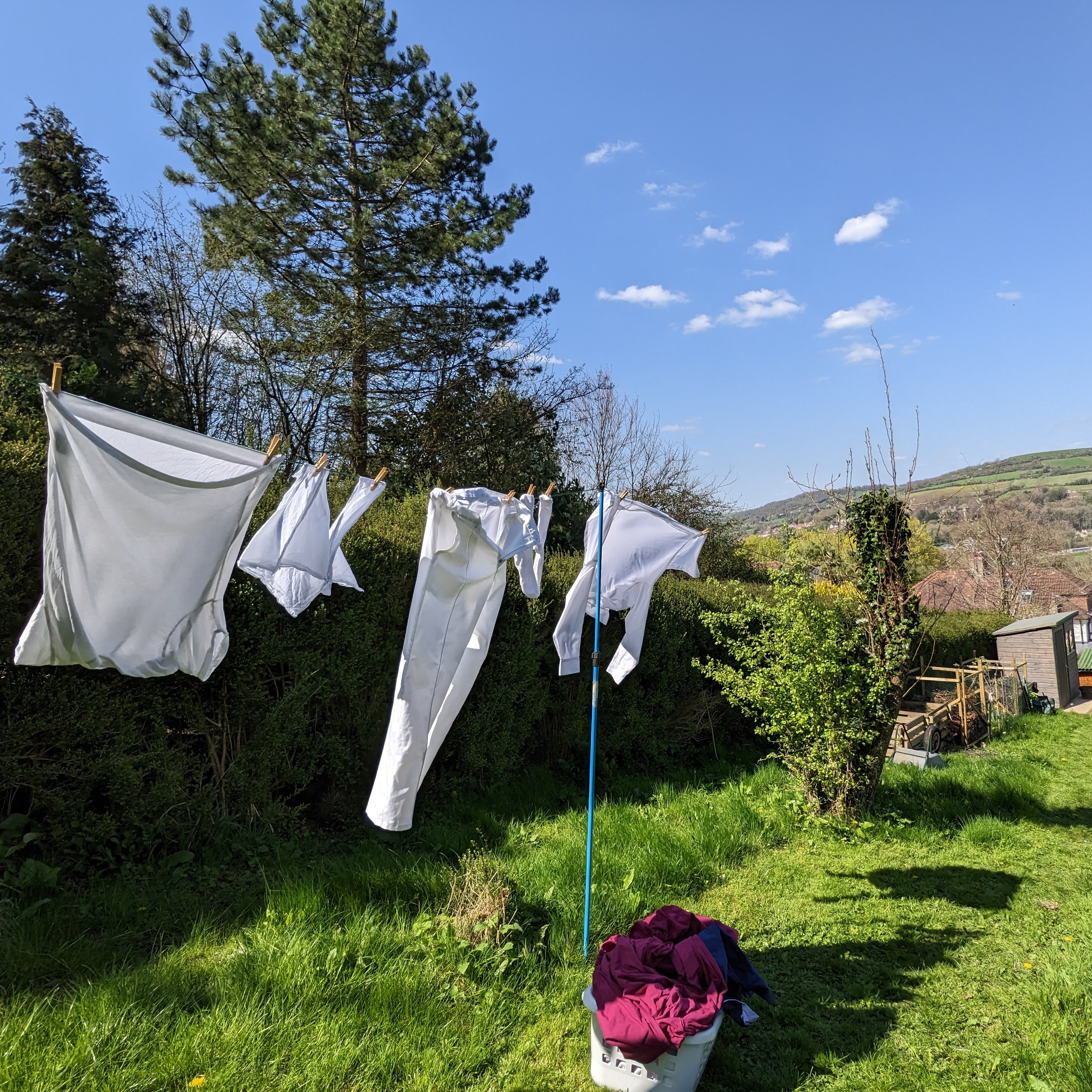 White kit hanging out to dry, with Little Solsbury hill in the background.